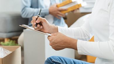 person writing on clipboard