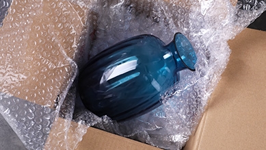 glass vase in a moving box