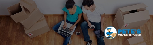 Two People Sitting by Moving Boxes