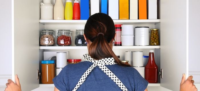 How to Pack Food for Moving: Person Looking At Stocked Cabinet